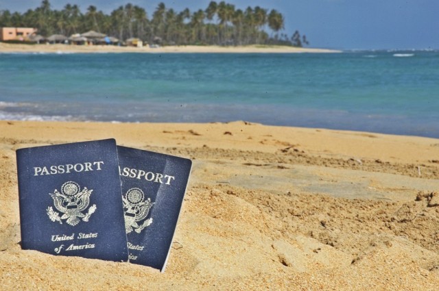 Travel from Punta Cana to La Romana - Two U.S. passports set in the sand at a beach in La Romana, Dominican Republic