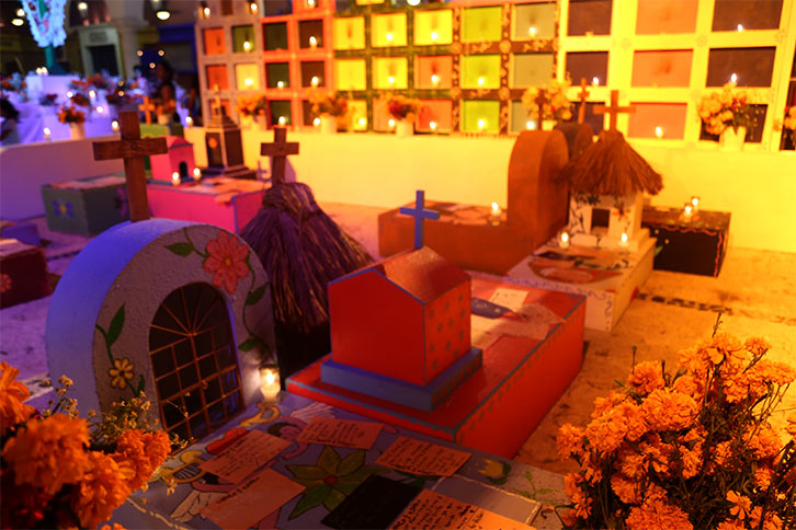 Candles on tombstones during Día de Muertos in Xcaret