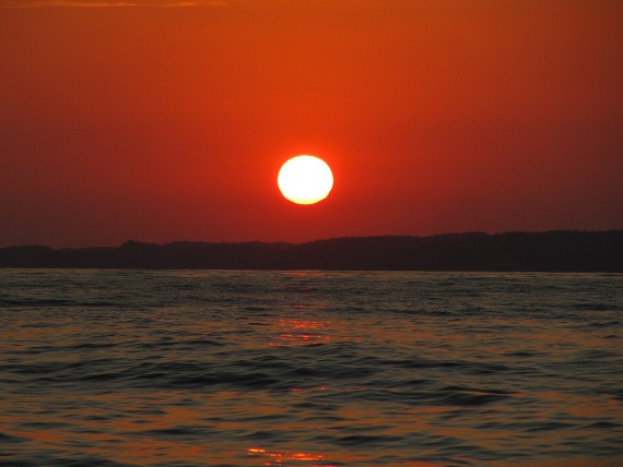 The sun sets over the Pacific Ocean in Huatluco, Mexico