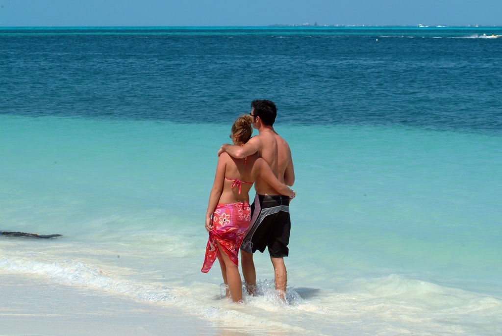 Couple walking the Caribbean beach