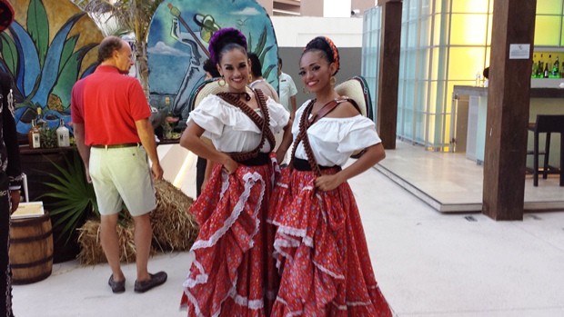 Two women posing in traditional outfits from the Mexican Revolution at Secrets The Vine's anniversary celebration