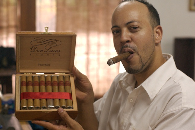 A man with a cigar showing off a cigar box at the Don Lucas Cigar Shop in Punta Cana