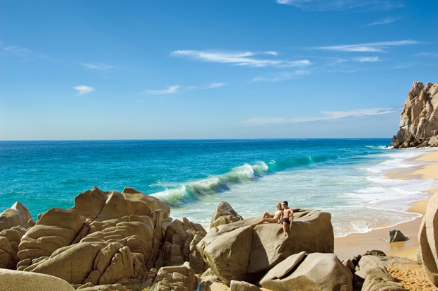 Here a couple relaxes on the rocks at Lover's Beach in Los Cabos