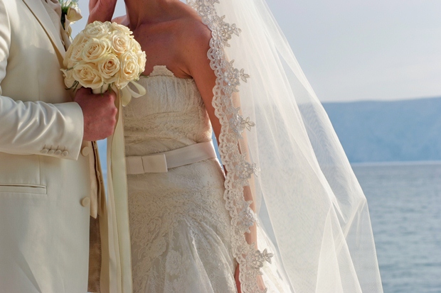 A bride and groom taking their vows at a beach wedding