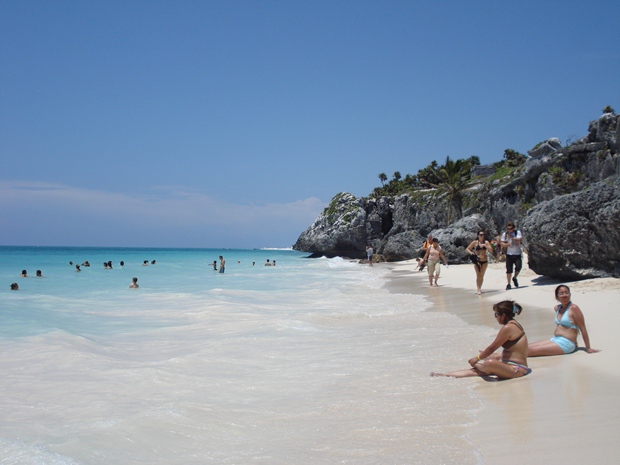 Vacationers enjoy the beach just in front of the Maya ruins of Tulum, Mexico