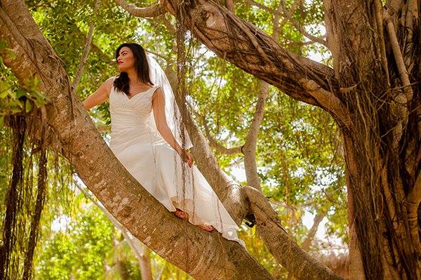 A bride-to-be up in a tree at a photo shoot in the Riviera Maya