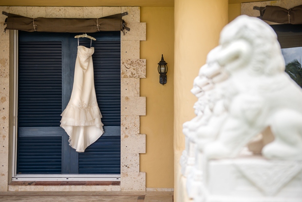 A white wedding dress hangs outside the window of a five-star hotel in the Riviera Maya