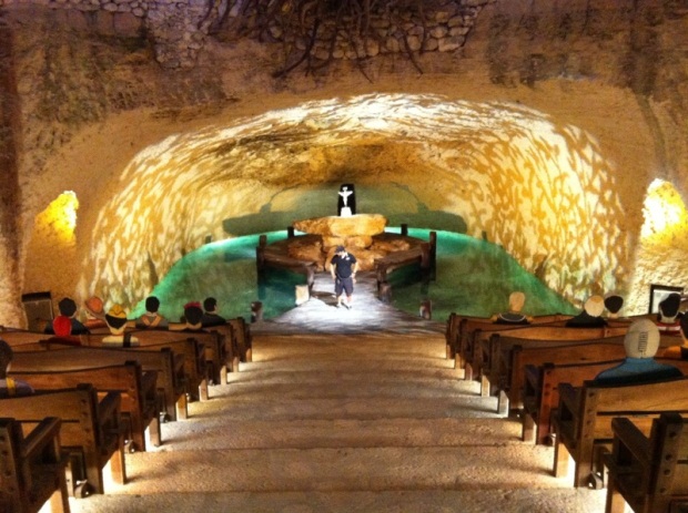 Wooden pews descend down into a Mayan cenote at a wedding ceremony in Xcaret, Riviera Maya, Mexico.