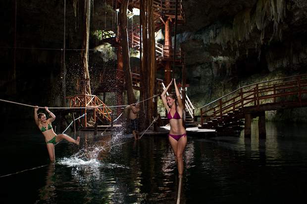 Two women gliding on a zip line during the Ek Balam tour to the Cenote Maya in the Yucatan Peninsula, Mexico