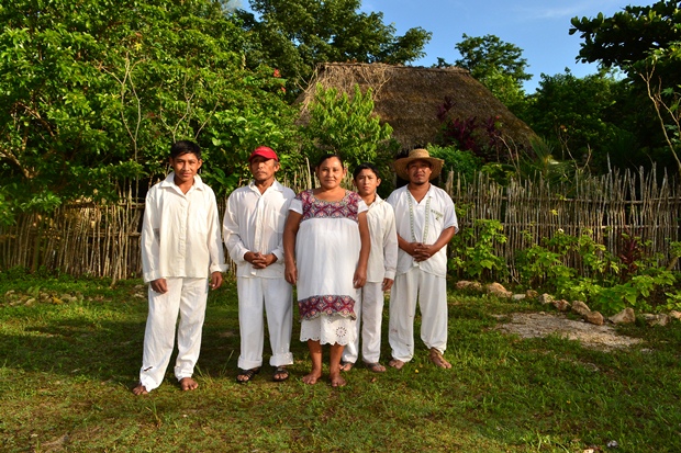 A Maya family poses in front of their hut along the road to the Ek Balam tour