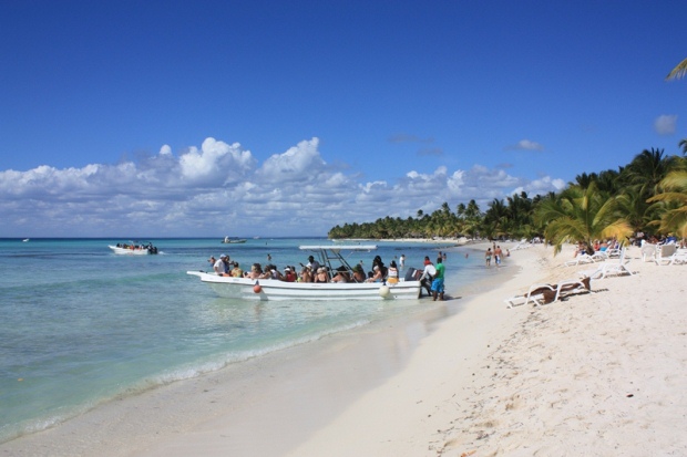 A boat of tourists arrives to the shores of Saona Island just off the coast of Punta Cana