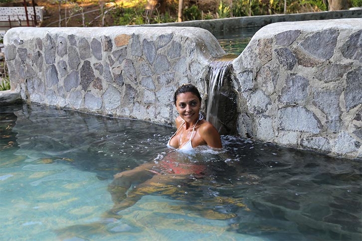 Woman relaxing in healing thermal waters in Costa Rica