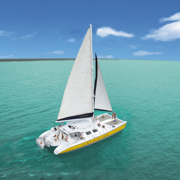 A catamaran sails off the coast of the Riviera Maya on an Amstar dmc Catamaran Day & Snorkel Tour