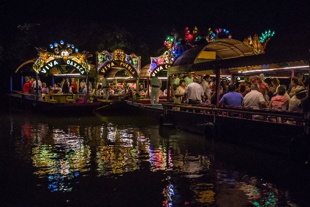 The wooden gondola-style boats set off with Amstar dmc guests on an evening dinner cruise in the Riviera Maya's Xoximilco