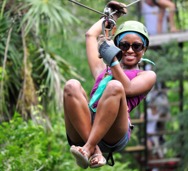 Woman sliding down rope on fit vacation