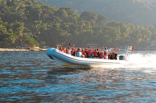 A group of tourists travel in a speedboat organized by Amstar dmc for the Outdoor Adventure tour in Puerto Vallarta.