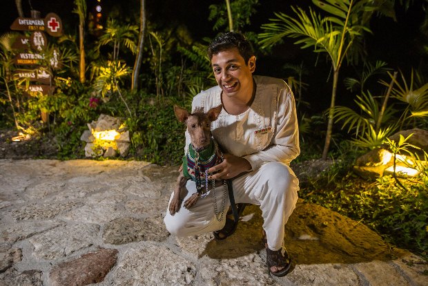 A staff members holds up a Mexican dog at Xoximilco Cancun in Mexico