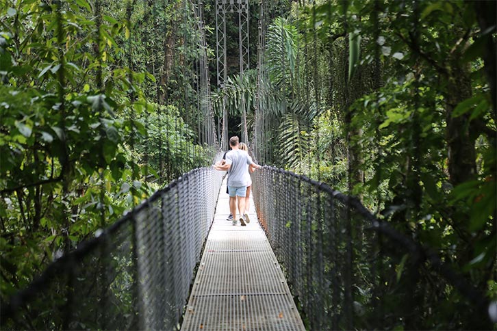 man and woman on the eco tour in rainforest