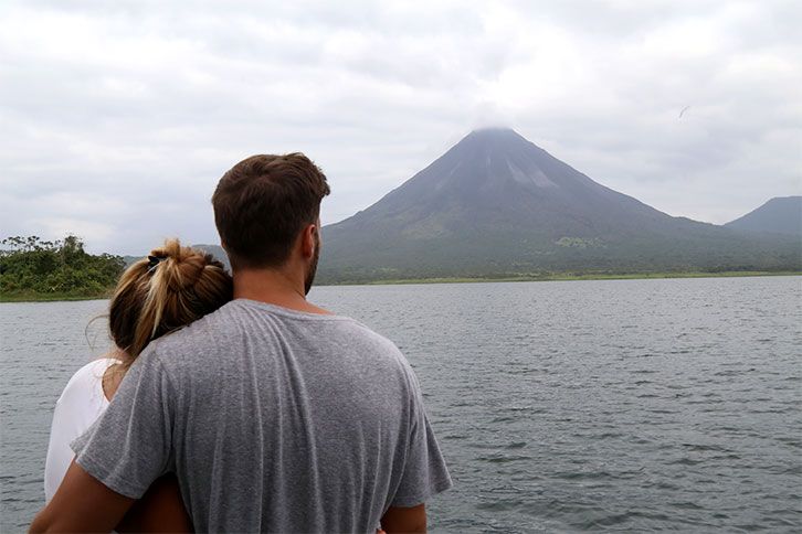 Couple gazing at Arenal Volcano