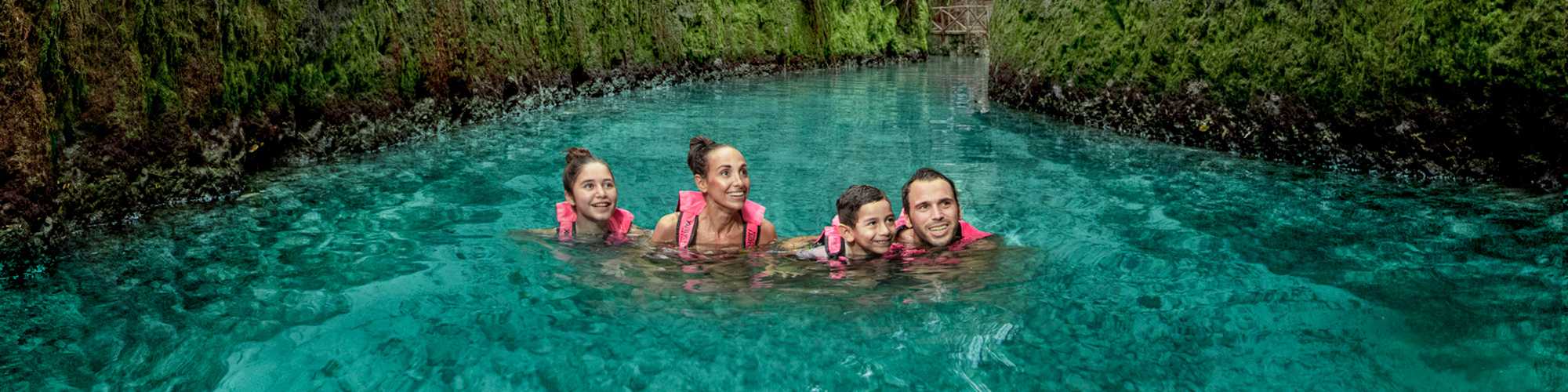 Family swimming in Xcaret Park