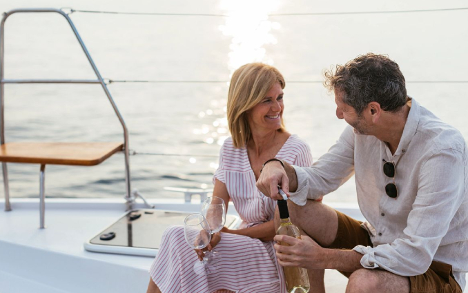 Couple enjoying the sunset aboard a Caramaran