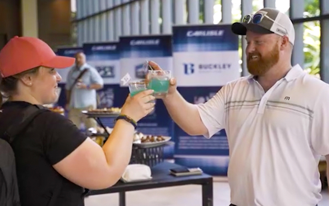 2 people clinking glasses at a retirement event