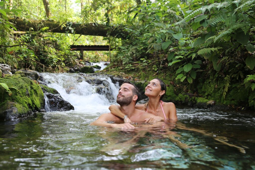 Couple swimming in a natural pool in Sensoria Costa Rica