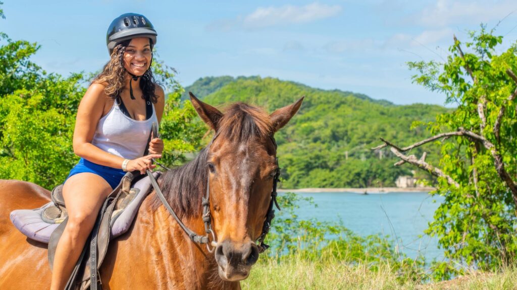 Woman riding a horse in the Ocean Outpost Tour