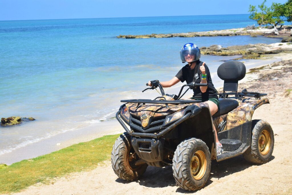 Riding an ATV on the beach as part of the Jamwest tour in Jamaica