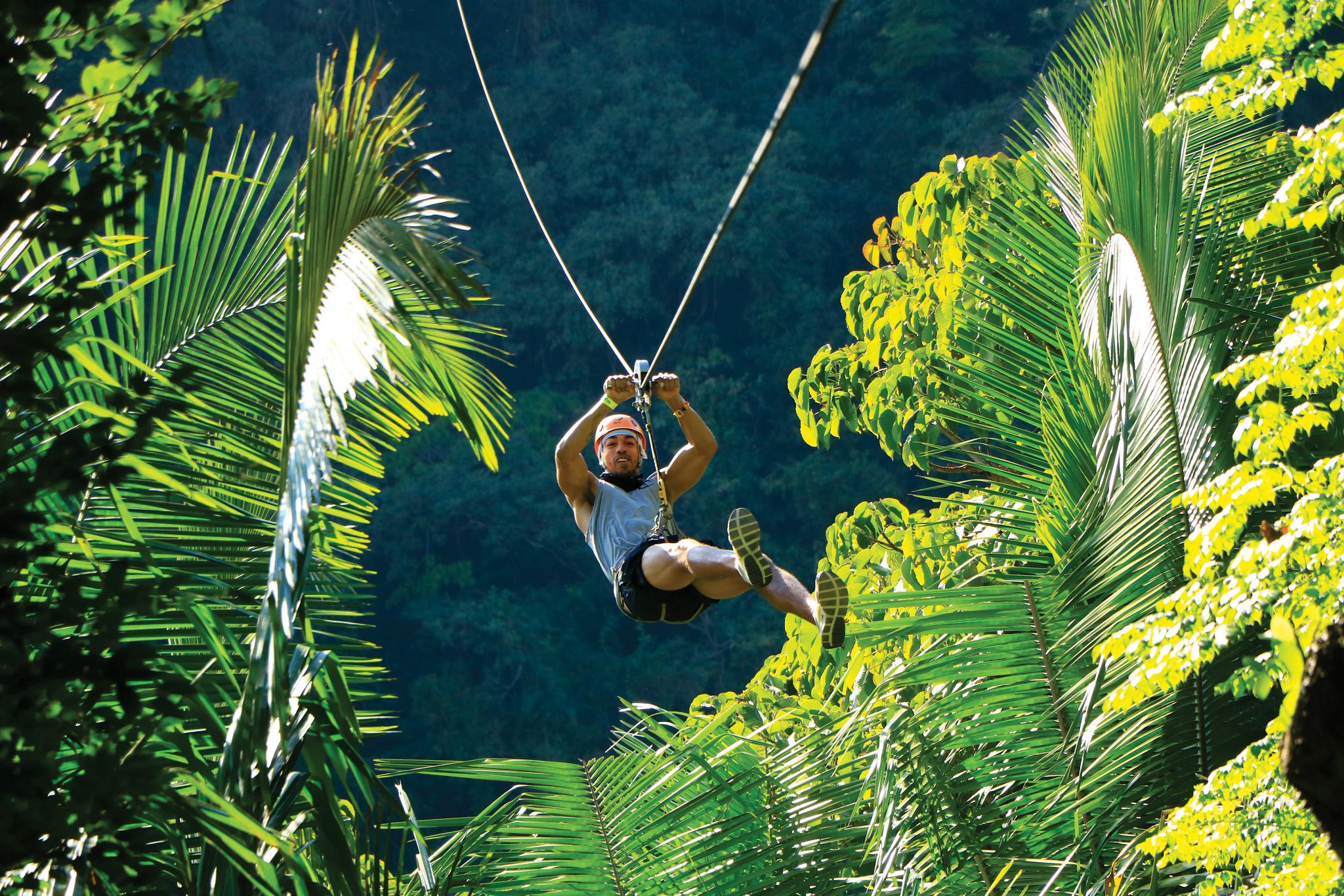 Person hanging from a zip line in Puerto Vallarta