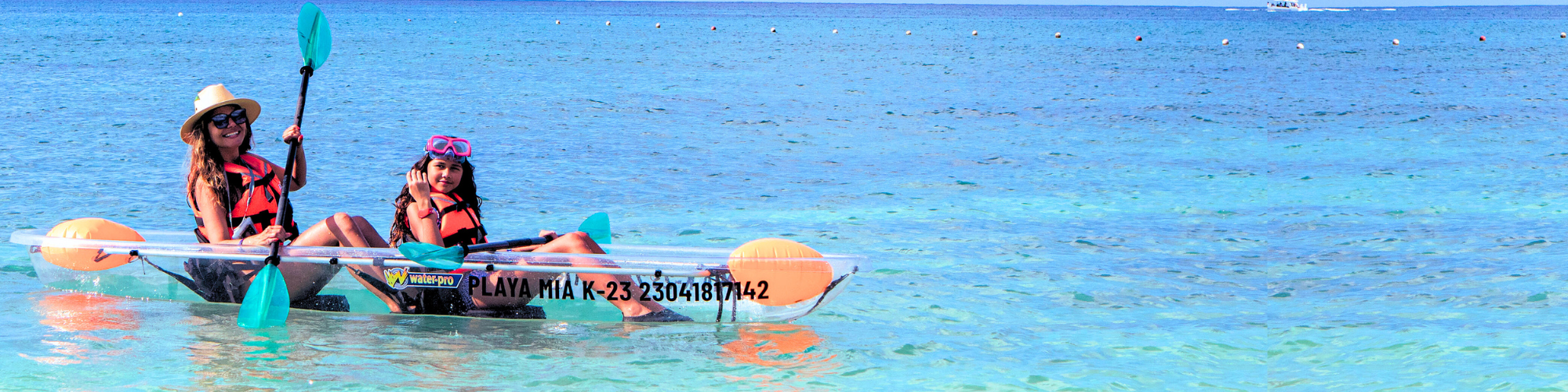 Mom and daughter on a kayak in Playa Mia