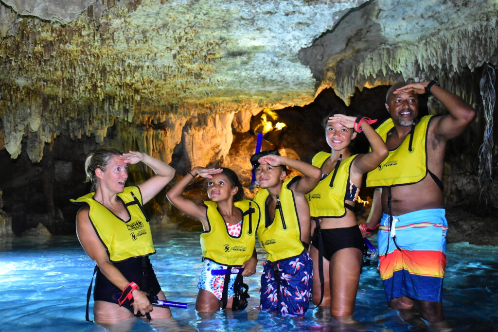 Family in a cenote cave in the Mexican Caribbean