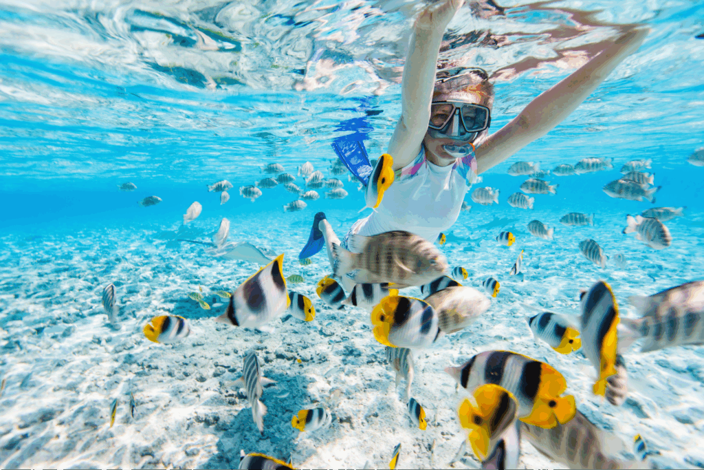A girl enjoying a snorkeling activity underwater in Hawaii.