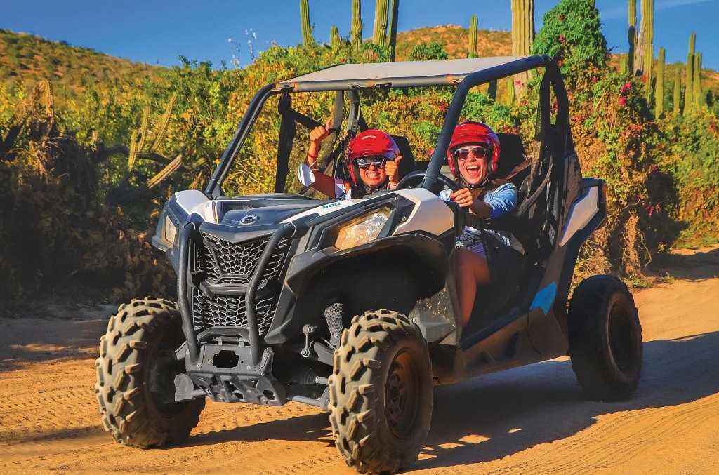 Friends on ATV adventure in the desert of Los Cabos, Mexico.