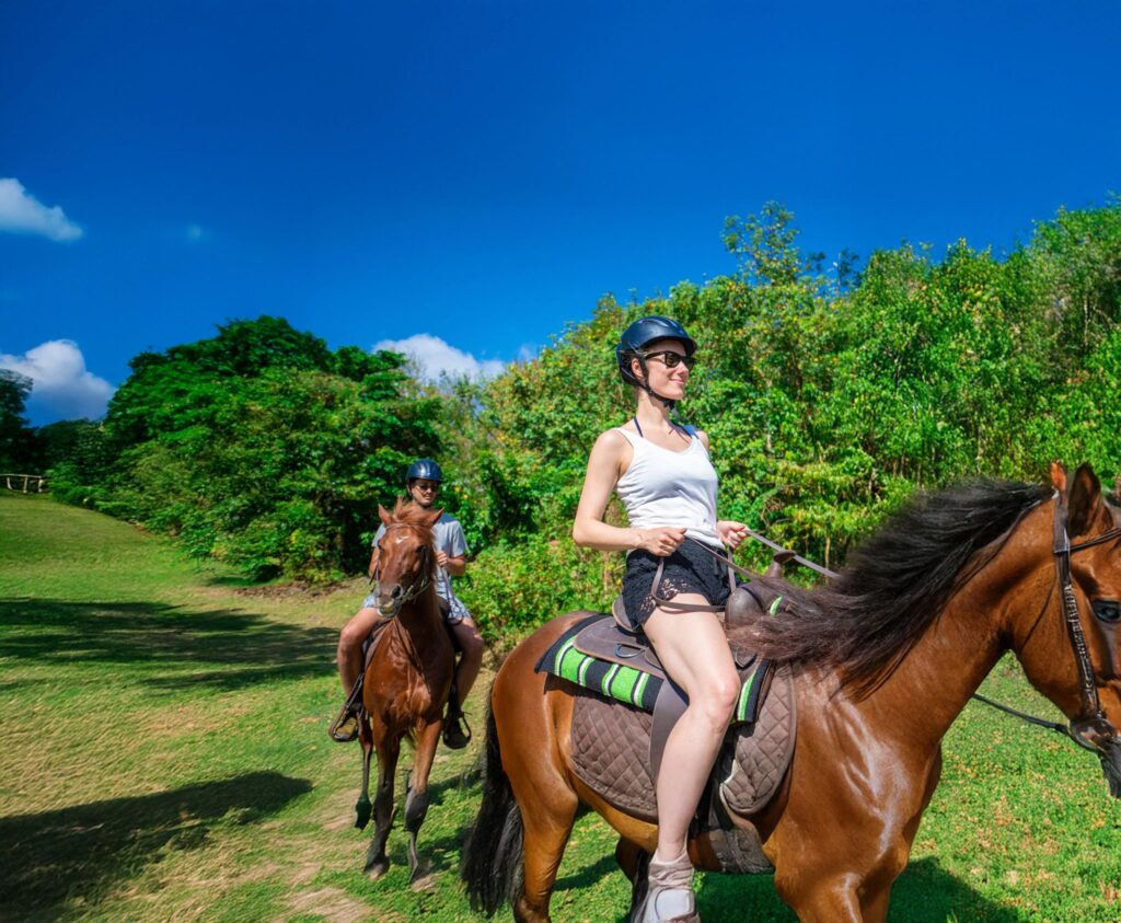 A couple riding horses on the island of Saint Lucia