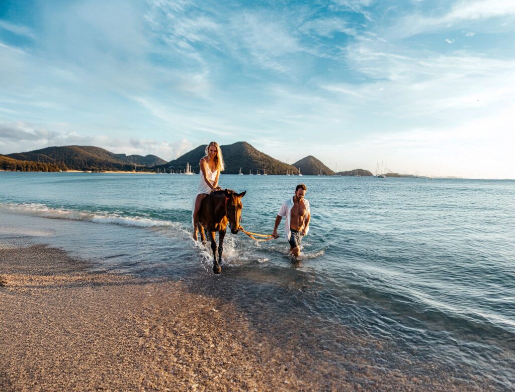 A couple riding horses on the island of Saint Lucia
