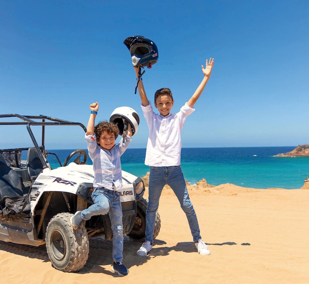 Kids at mini RZR vehicle in Los Cabos, Mexico.