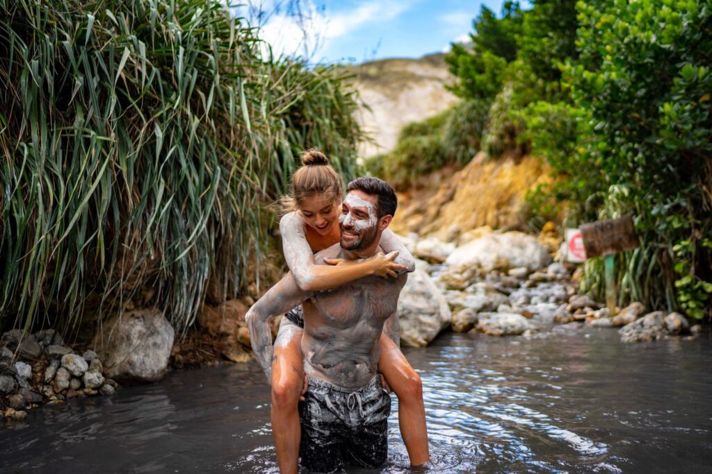 A couple in naturally heated mud baths.