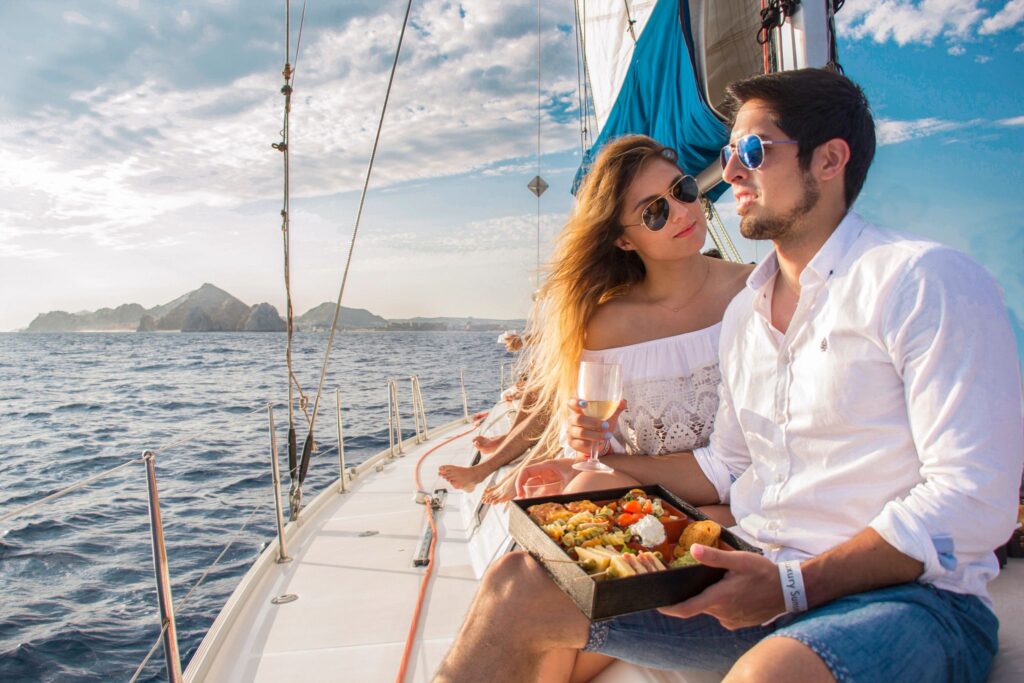 couple enjoys a romantic meal on a sailboat in Los Cabos, Mexico.