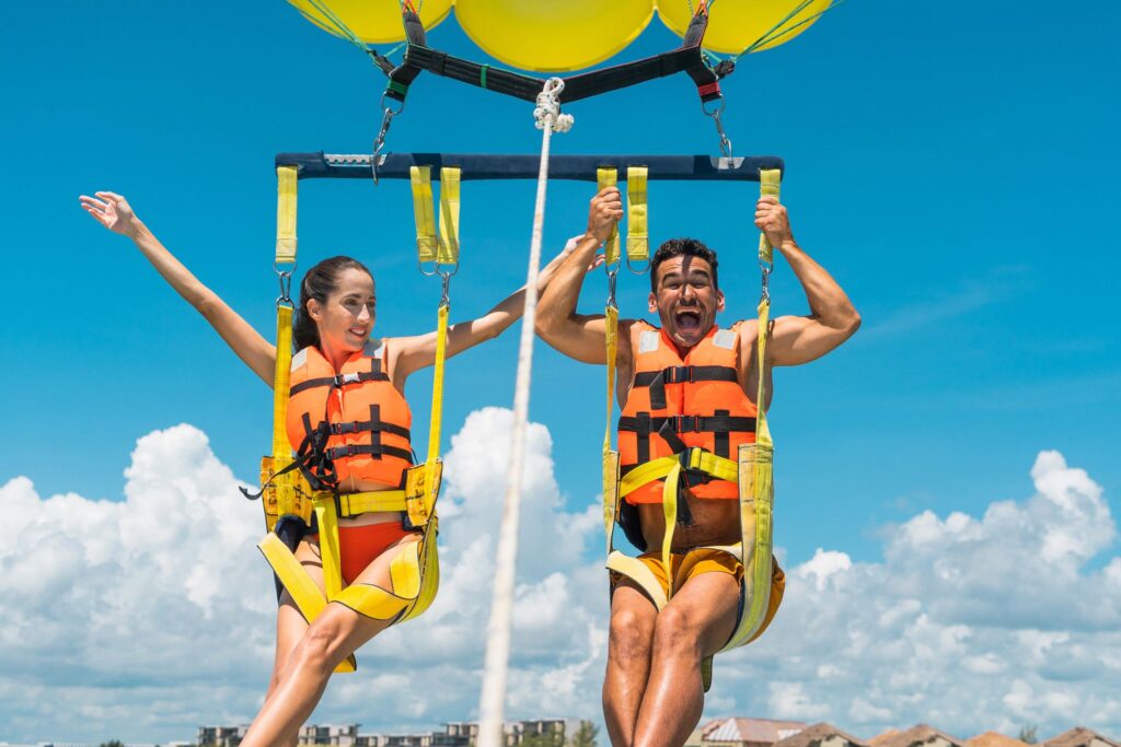 Couple enjoying a parasailing tour in the Riviera Maya