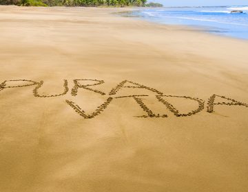 Pura vida escrito en arena en playa de Guanacaste, Costa Rica