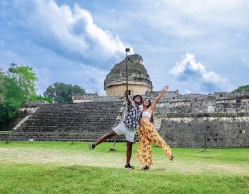 Couple taking a picture infront od the observatory in Chichen Itza