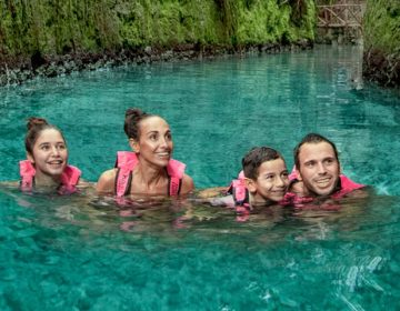Family swimming in Xcaret Park